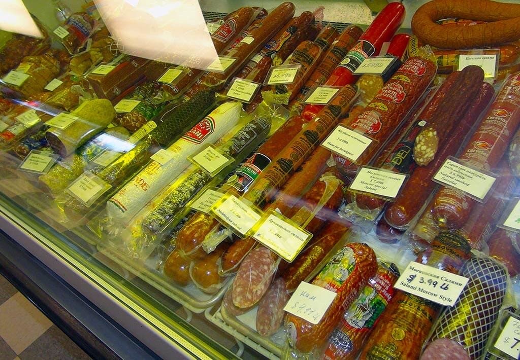 Kolbasa and smoked sausage varieties in the deli counter at Kalinka Euro Market