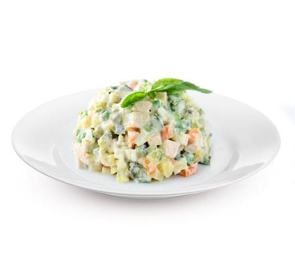 Olivier potato salad served on a white plate